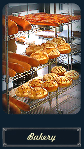 Fresh baked  Artisan loaves on the rack,ready for you at La Boulangerie du Village...